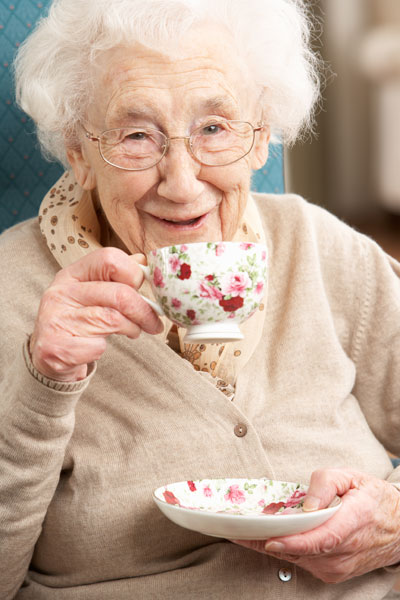 Elderly woman with cup of tea